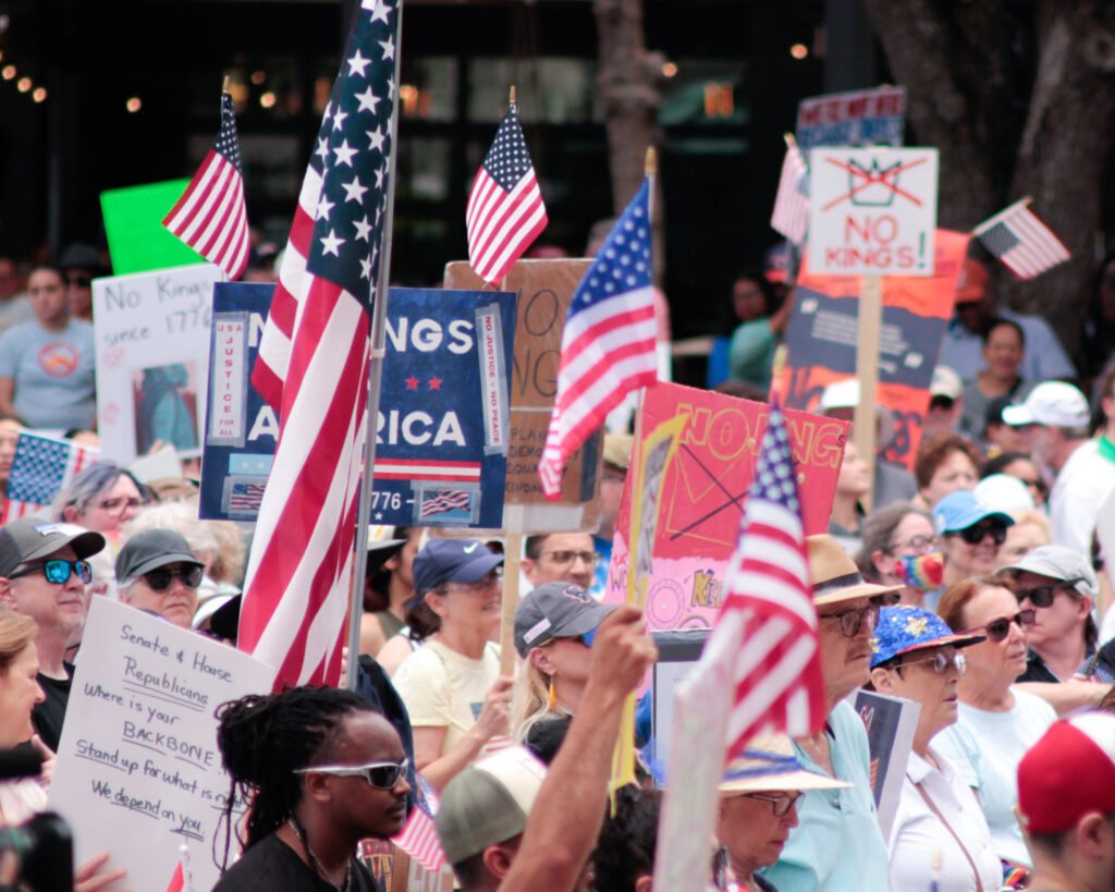 people holding up signs and flags at rally